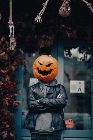 Guy with a pumpkin head poses for the cameraの写真素材