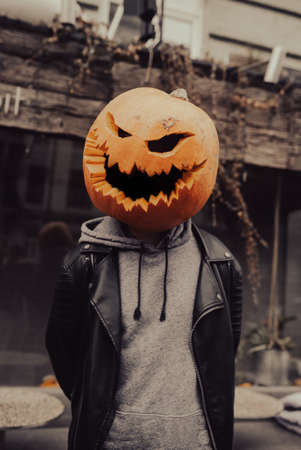 Guy with a pumpkin head poses for the cameraの写真素材