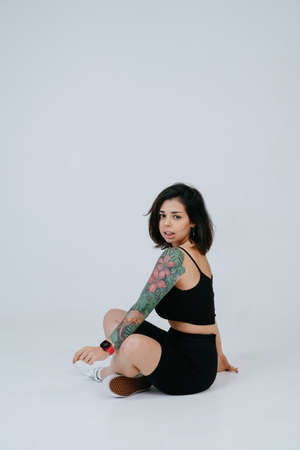 Beautiful Young Female Model in Isolated Studio Settingの写真素材