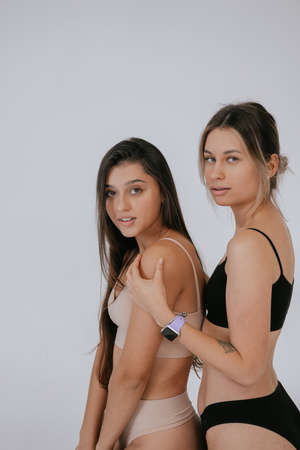 Two diverse models wearing underwear stand side to the cameraの写真素材
