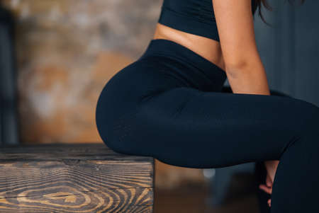 Sporty woman in sportswear resting on bench at fitness.の写真素材