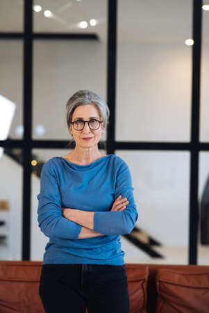 serious mature woman with her head held high looking at camera