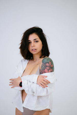 Young woman wearing comfortable underwear and a open shirtの写真素材