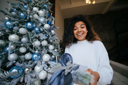 Woman gives a gift to his friend in the camera.の写真素材