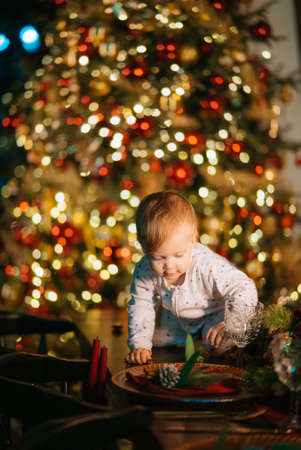 Little boy playing by the christmas treeの写真素材