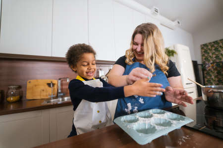 Mom and daughter prepare a baking dish