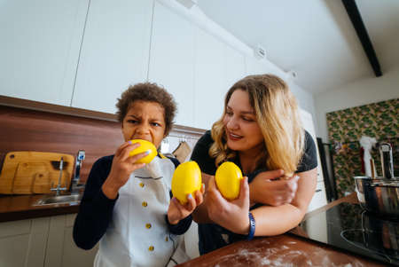 Mom and daughter choose a lemon for cookingの写真素材