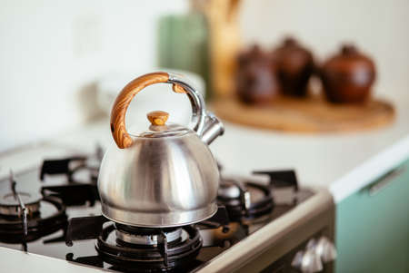 Kettle on the gas stove. Interior of modern kitchenの写真素材