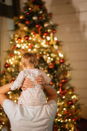 Feet of a little boy on the background of a Christmas treeの写真素材