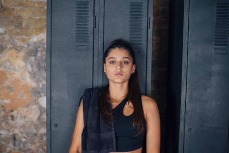 Attractive woman looking to the camera with a towel on her shoulder