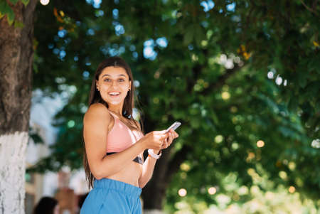 Photo of charming pretty young lady communicating modern gadgetの写真素材
