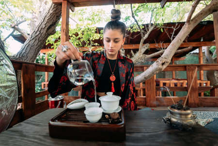 The tea ceremony. Woman pours water in a tea bowl.の写真素材