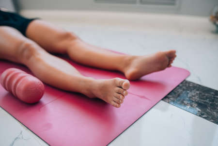 Cropped photo of a woman lying on a yoga matの写真素材