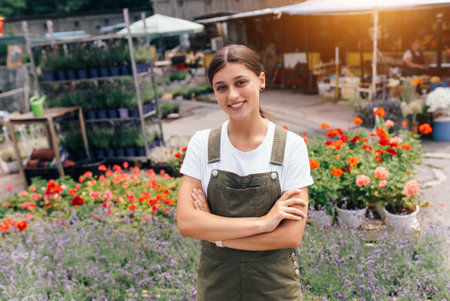 Young woman standing in front of a counter with flowersの写真素材