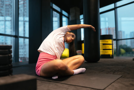 Young sporty woman practicing yoga, working out, wearing sportswear