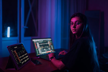Attractive young woman working in home at night.