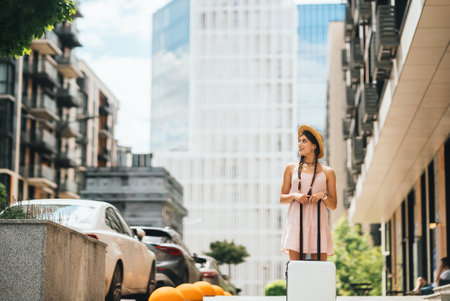 Young woman with suitcase and looks to the sideの写真素材
