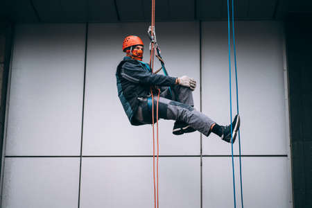Industrial climber in uniform and helmet risesの写真素材
