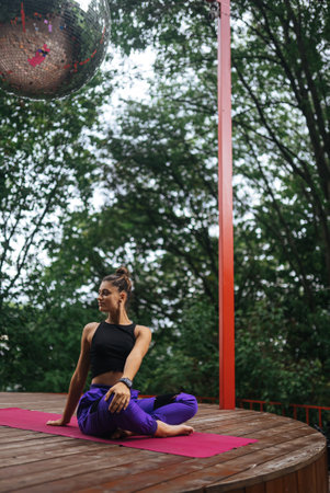 Young woman is practising yoga sitting in the lotus position