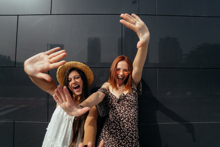 Two attractive young women fooling around in fresh air.の写真素材
