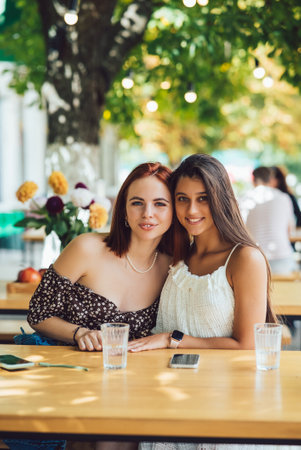 Close-up portrait of two female at summer street cafeの写真素材