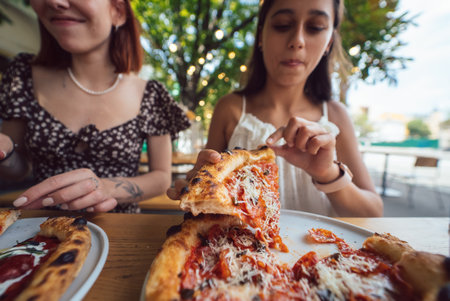 Charming beautiful woman takes a slice of pizza.の写真素材