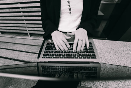 Close up image of woman hands typing on laptop.の写真素材