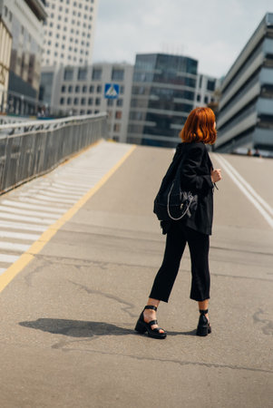 Young woman with a backpack on the road
