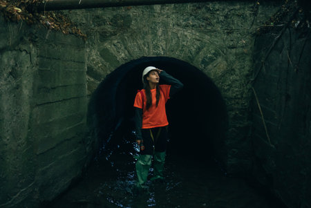 A young woman digger comes out of a rain collectorの写真素材
