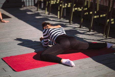 Yogi woman and diverse group of sporty people practicing yoga