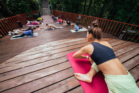 Group of young sporty people practicing yoga lesson with instructor,の写真素材