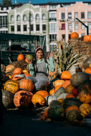 Female farmer holding ripe pumpkin and showing ok.の写真素材