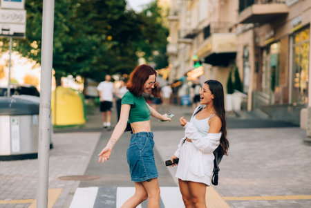 Happy meeting of two friends hugging in the streetの写真素材
