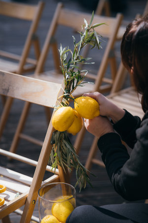 The woman decorates a chair. Decoration details.の写真素材