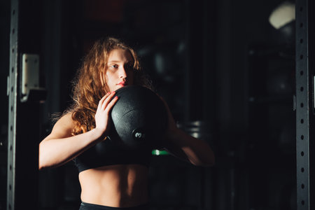 Athletic Beautiful Woman with ball at gym.の写真素材