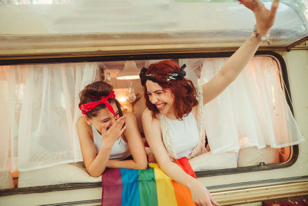 Portrait of a cute lesbian couple. Two girls spend time tenderly together in a camper trailer. Love and attitude. LGBT conceptの写真素材