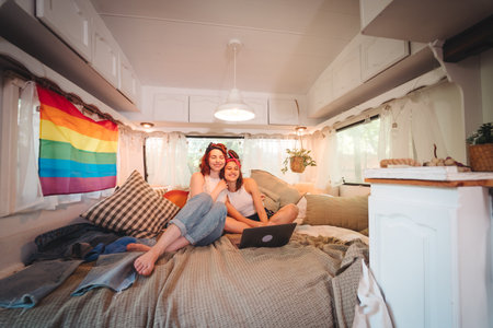 Portrait of a cute lesbian couple. Two girls spend time tenderly together in a camper trailer. Love and attitude. LGBT conceptの写真素材