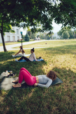 The girl is at a group yoga session in the park.の写真素材