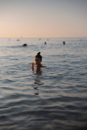 Experience the Serene Evening Swim in the Calm Waters of a Beautiful Tropical Oceanの写真素材