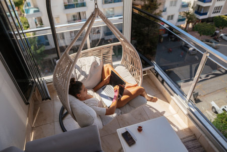 I relax on a stylish balcony hammock, sipping coffee and reading my favorite book or magazine