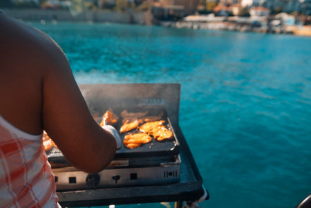 Grilling Seafood by the Beautiful Water Adds a Unique Touch to All Outdoor Gatherings and Eventsの写真素材