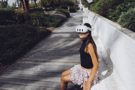 Delving into the World of Virtual Reality While Surrounded by a Calm and Beautiful Outdoor Settingの写真素材