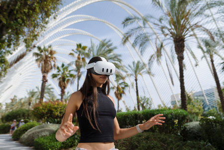 A woman engaging in the exciting world of virtual reality while enjoying an outdoor setting