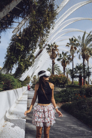 A Young Woman Engaged in an Exploration of Nature While Wearing a Virtual Reality Headsetの写真素材