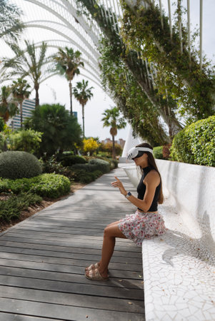 A woman is enjoying a moment of relaxation in a beautifully lush tropical garden setting