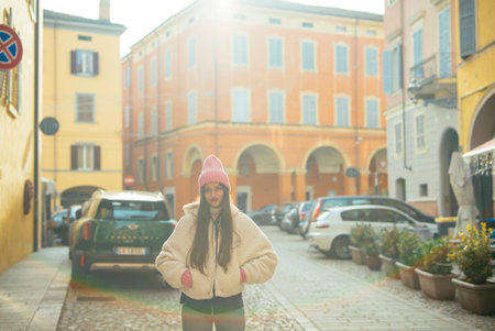 A young woman enjoying a warm and sunny day in a charming and picturesque European squareの写真素材