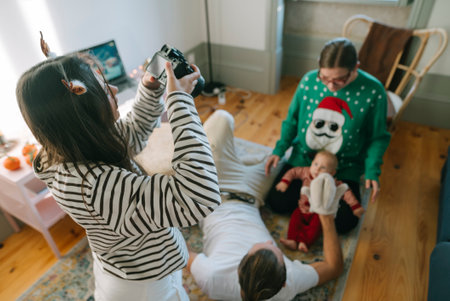 Family Christmas Gathering Featuring a Baby Dressed in a Festively Colorful Sweaterの写真素材