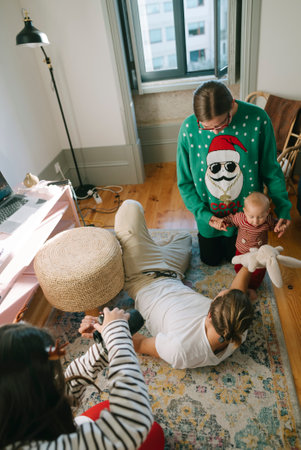 Delightful family gathering with a joyful baby in festive colorful sweaters this winterの写真素材