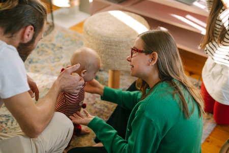 textFamily Joy Engage with Baby in a Cozy Living Room,keywordsbaby,bonding,family