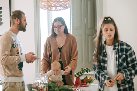 Family Gathering Engaging in Joyful Holiday Preparations with the Baby and Loved Ones This Seasonの写真素材
